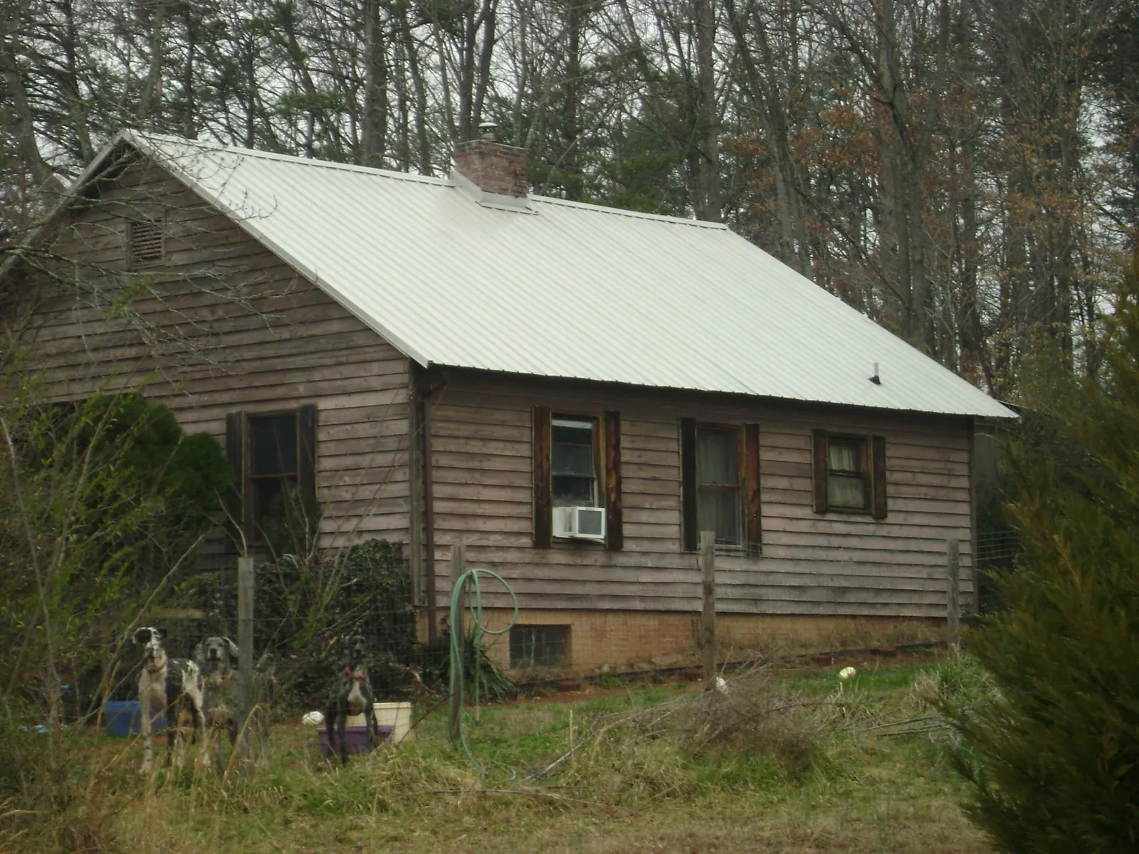 White metal roof on an old wood sided farmhouse, from a Metal Roof Installation job in Pennsburg